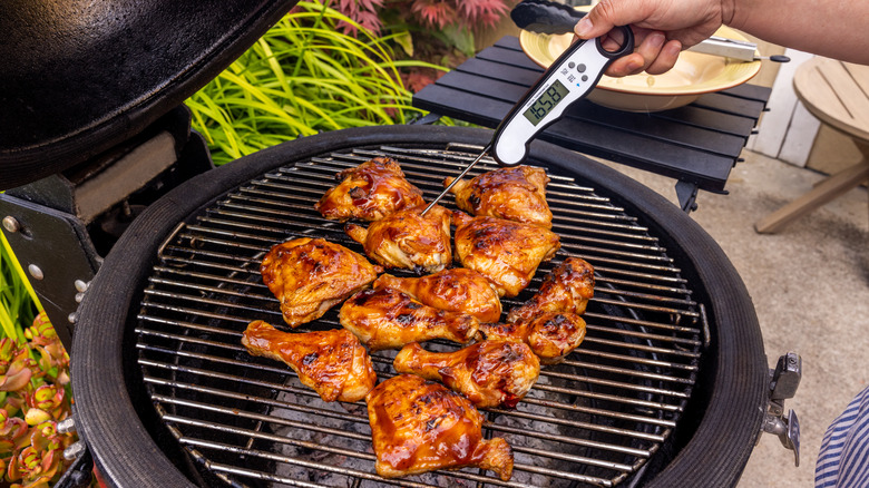 Chicken on grill with thermometer