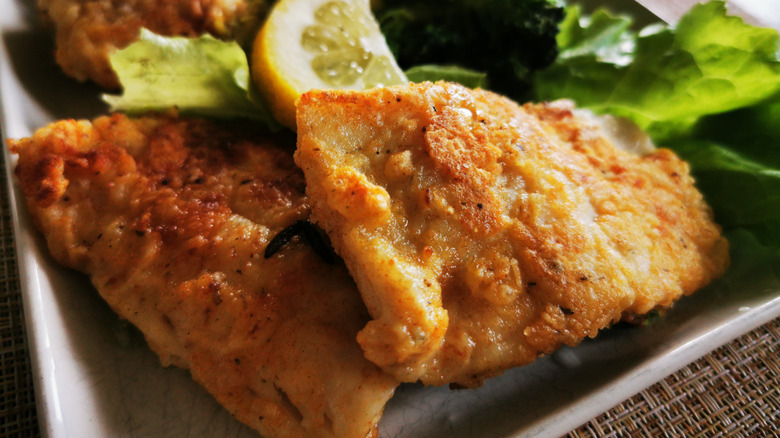 Fried walleye on tray with lemon