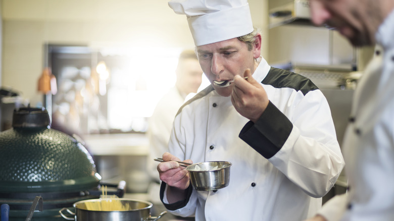 Chef tasting food in kitchen