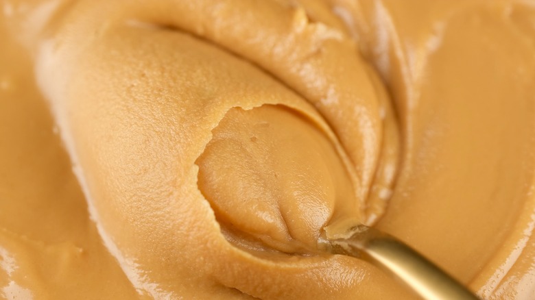 spoon in creamy peanut butter