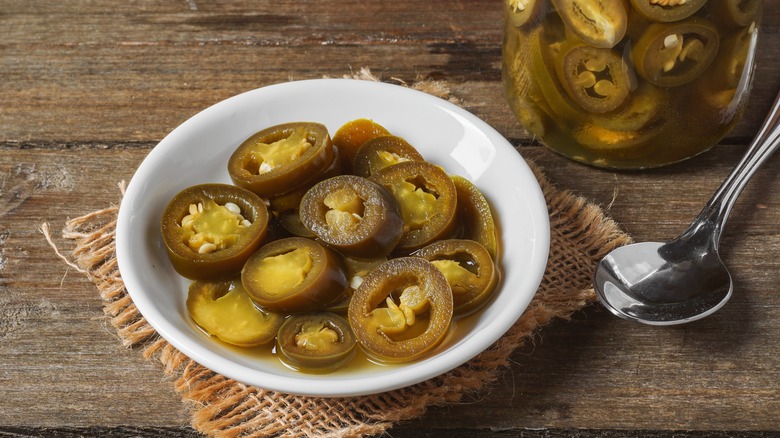 Canned jalapeños in white bowl