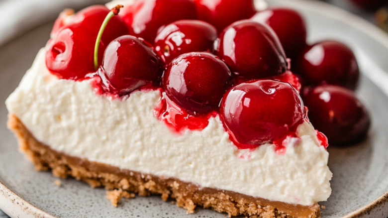 Slice of cherry delight on white plate.