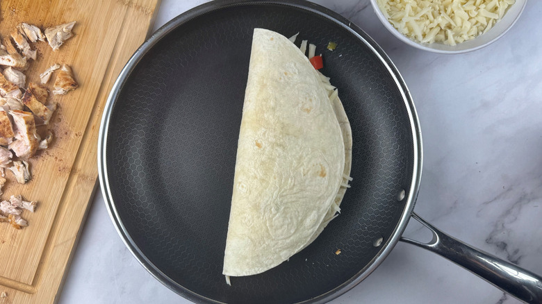 Folded over quesadilla in skillet