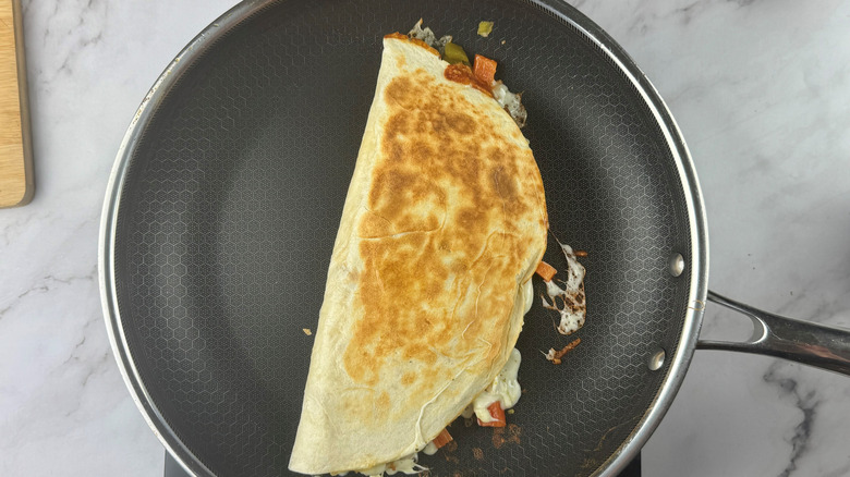 Folded over quesadilla in skillet