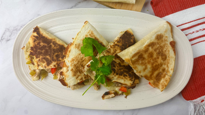 Quesadilla slices on platter with cilantro