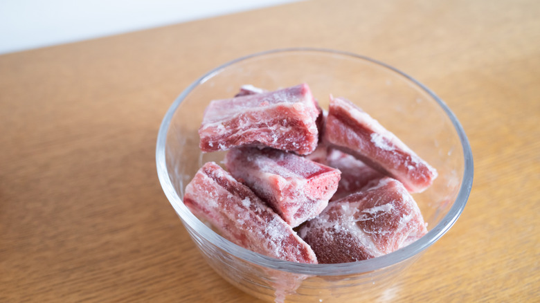 Raw meat in a bowl on the kitchen counter