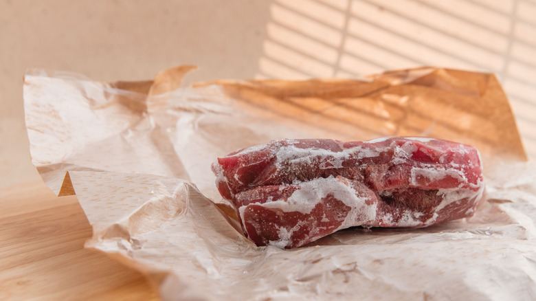 A frozen piece of beef on butcher paper