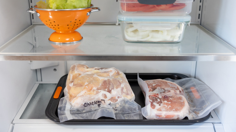 Two packages of frozen meat in the refrigerator