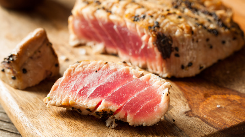 close up of homemade grilled sesame tuna steak with soy sauce