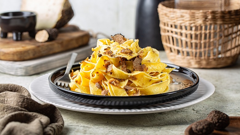 Plate of fettuccine pasta with shaved truffle on top