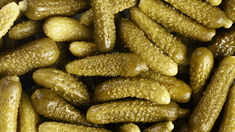 Close up of pile of cornichon pickles.