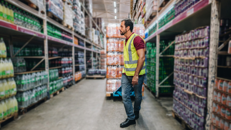 A man pulls a pallet at a warehouse store