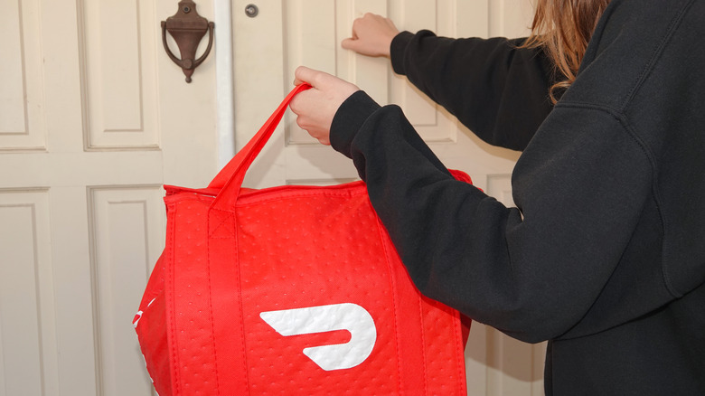 person making DoorDash delivery