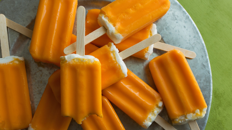 Orange creamsicles on metal tray