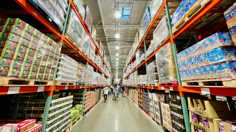 Costco interior with shoppers and large shelves.