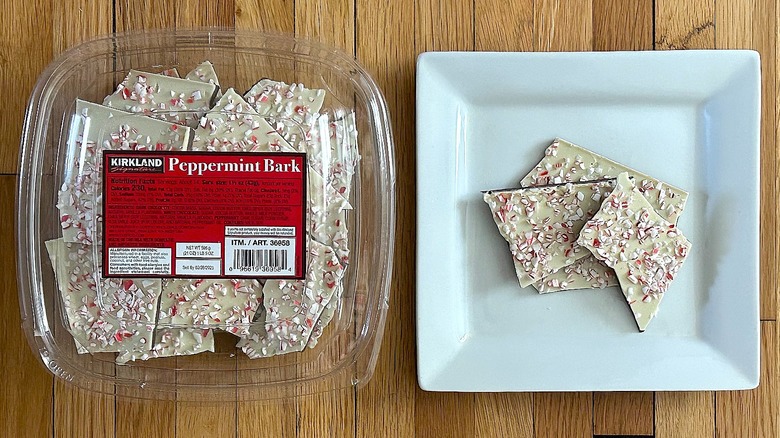 Container and pieces of Peppermint Bark on white square plate