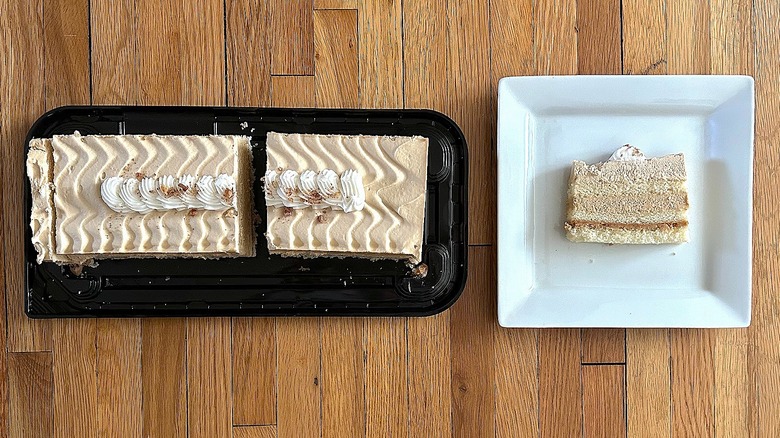 Whole and slice of Maple Butter Pecan Bar Cake on white square plate