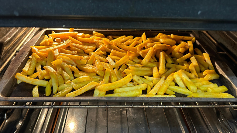 Frozen french fries bake in an oven