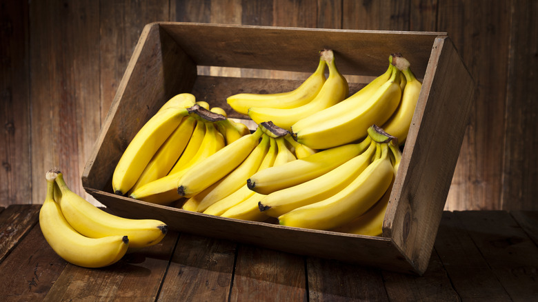 Banana bunches in wooden crate