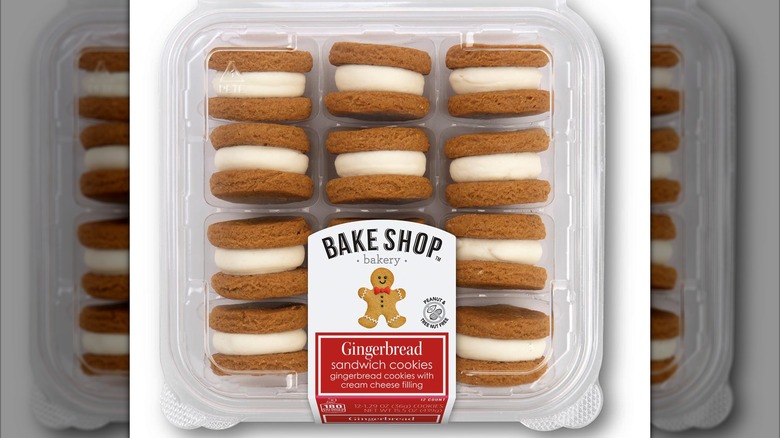 A plastic container with gingerbread cookie sandwiches.