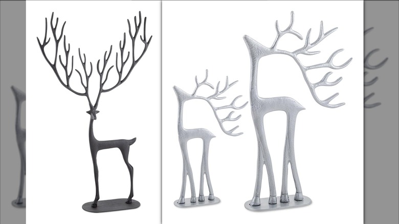 A black large sculpted reindeer and two silver reindeer.