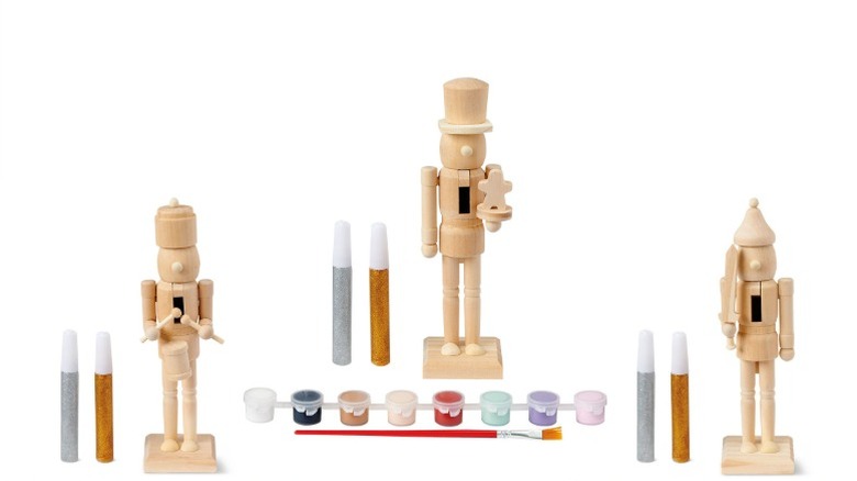 Three wooden paint your own nutcrackers with paints and glitter pens.