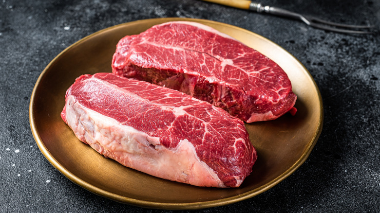 raw shoulder top blade beef steaks on a plate