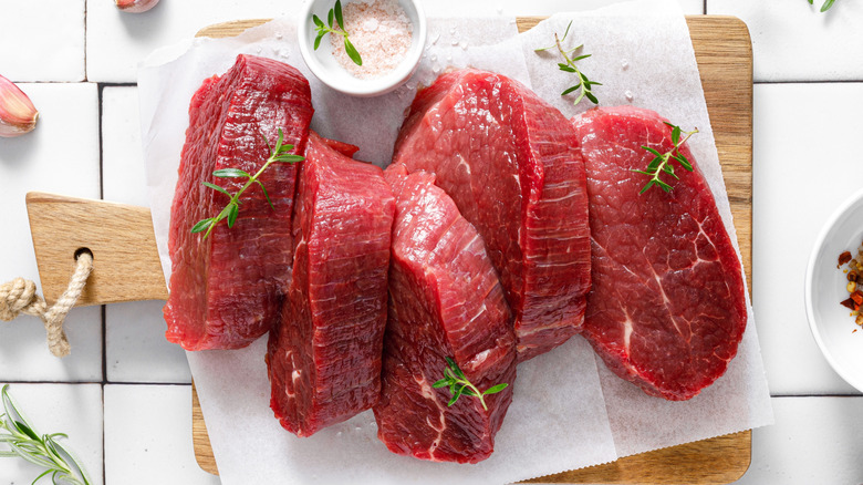 raw beef tenderloin meat, beef steaks with ingredients for cooking