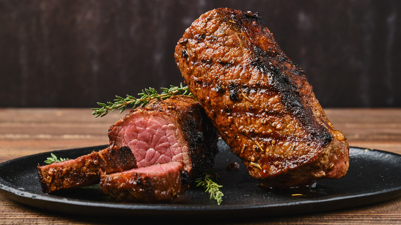 Closeup view of roasted beef brisket flat steak on a plate