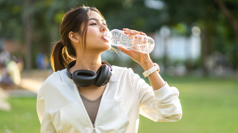 Woman drinking bottled water