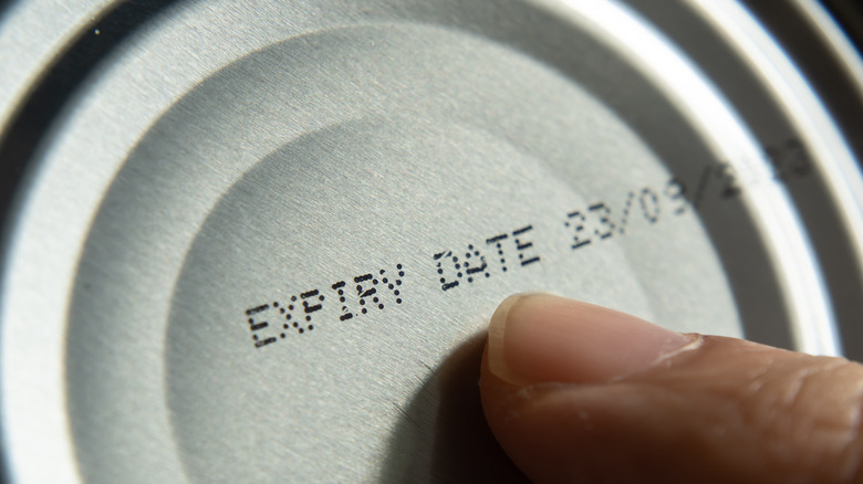 Finger pointing to expiry date