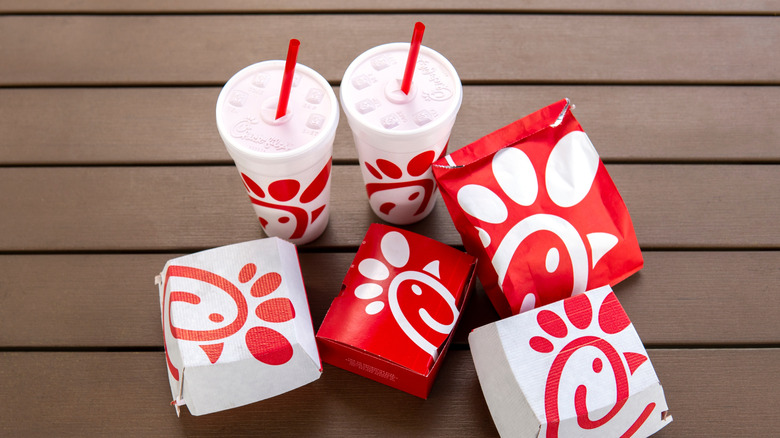 Chick-fil-A cups and food packages on a tabletop