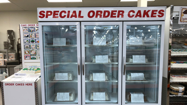 A Costco special order cakes case in a warehouse