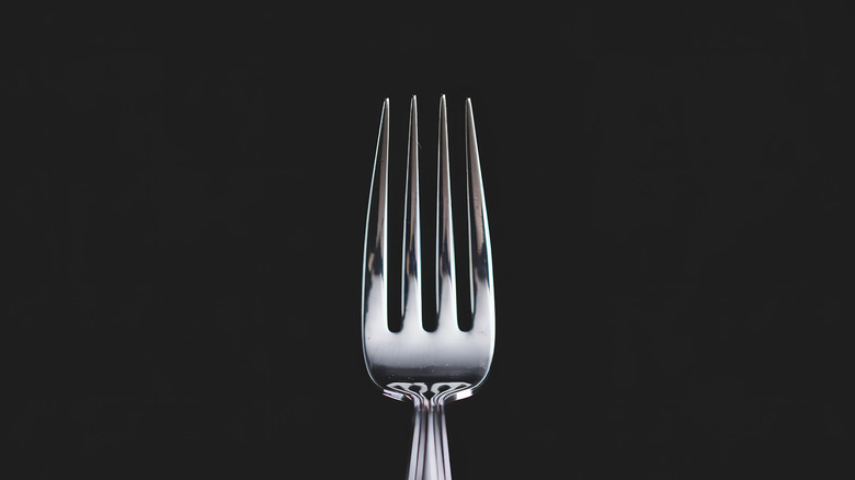 Closeup of fork on black background