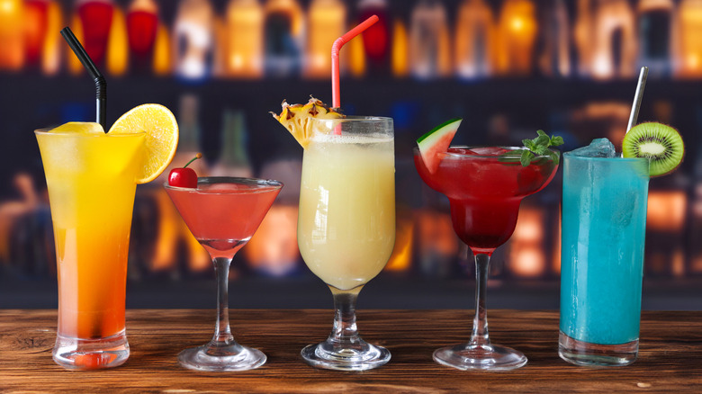 Close-up view of cocktails lined up on bar counter.