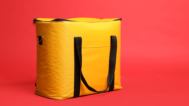 Yellow thermal bag for food with red background