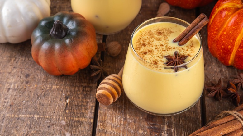 Eggnog in glass with cinnamon and star anise