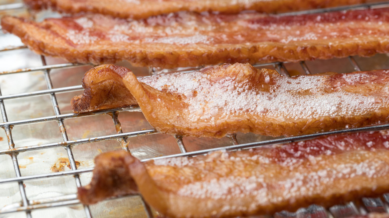 Bacon cooking over metal rack