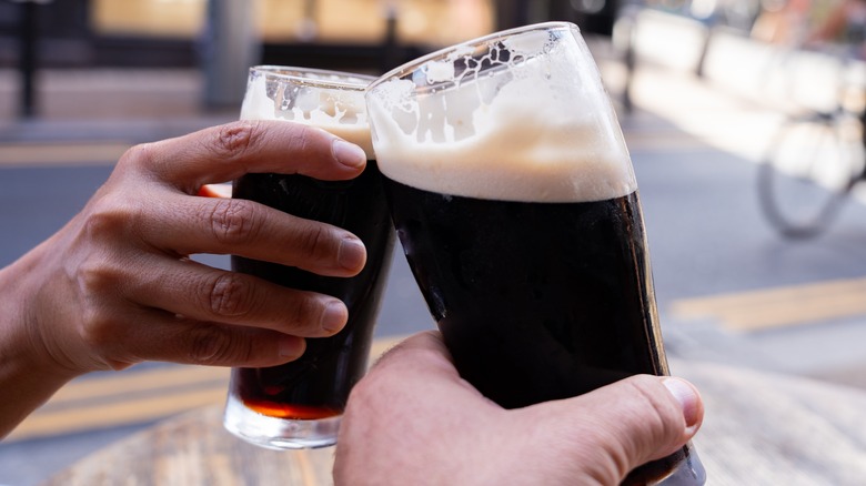 People clinking glasses of beer