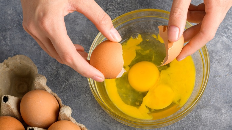 cracking eggs into a bowl