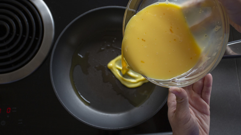 pouring eggs into nonstick pan