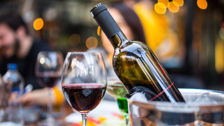 Wine bottle in bucket and wine glass