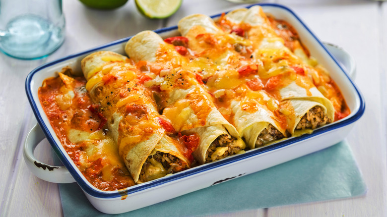 A pan of enchiladas with cheese