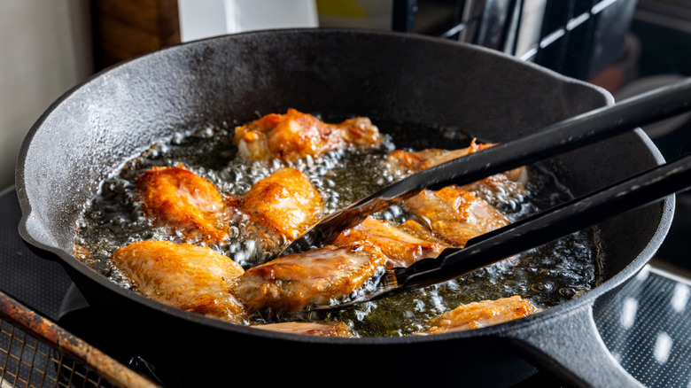 chicken wing fried until golden brown in bubbling hot vegetable oil