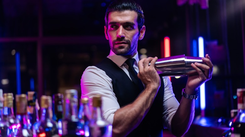 A bartender mixing a cocktail