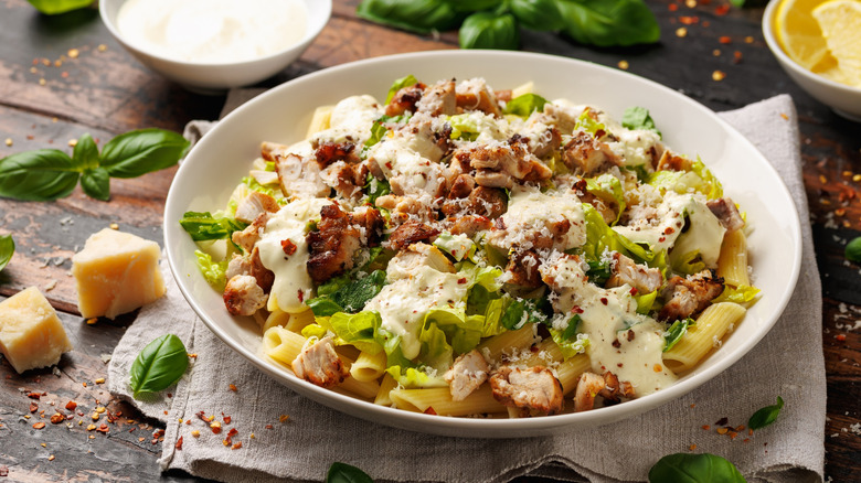 Caesar salad on pasta with grilled chicken