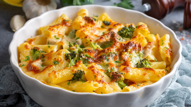 Broccoli and cheese pasta in white baking dish