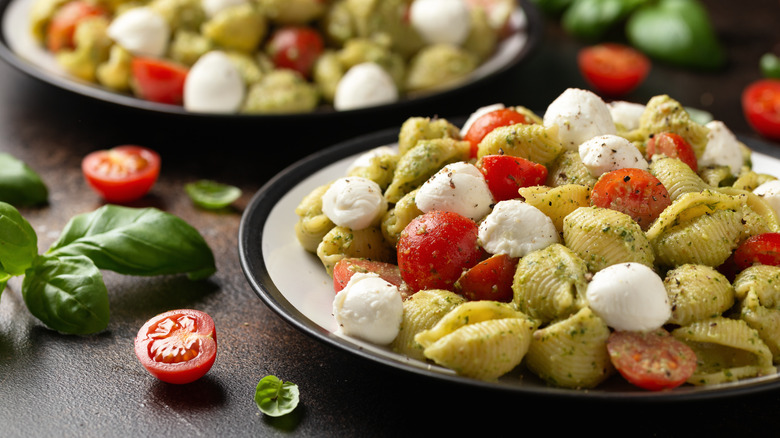 pesto pasta salad with shell-shaped pasta, cherry tomatoes, and ciliegine