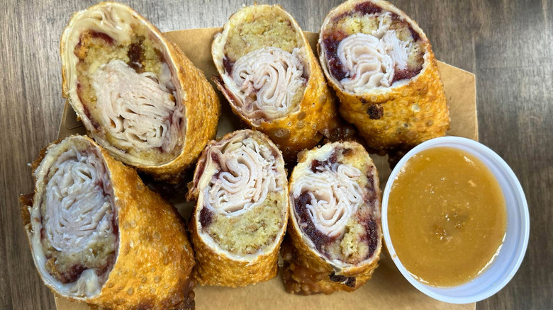 Eggroll halves filled with turkey, stuffing, and cranberry.