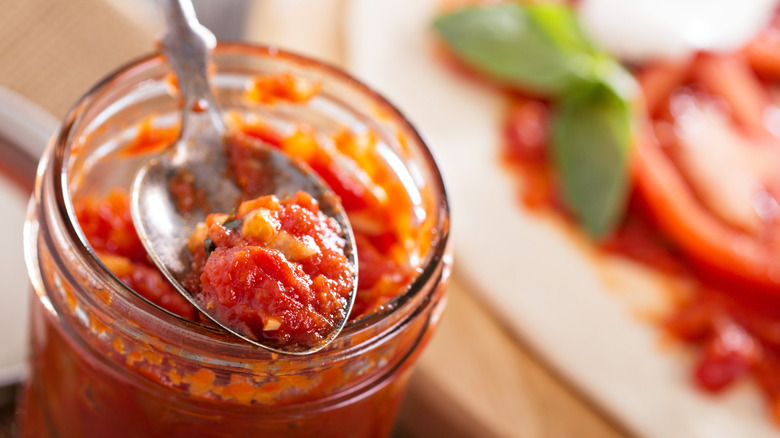 Jarred tomato sauce on spoon